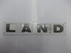 DAB500290 - Emblem – LAND – Silver – 28cm  by Land RoverBody Part Land Rover Range Rover Defender